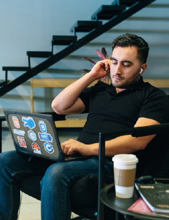 an engineer from ClickIT looking in his computer in a cafeteria